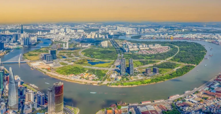 Aerial split view comparing Thao Dien green expat suburb with Thu Thiem high-rise skyline along Saigon River