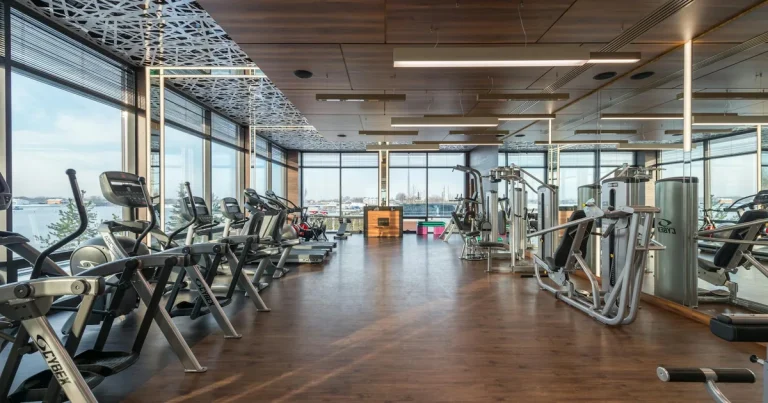 Modern apartment gym and rooftop pool overlooking the HCMC skyline