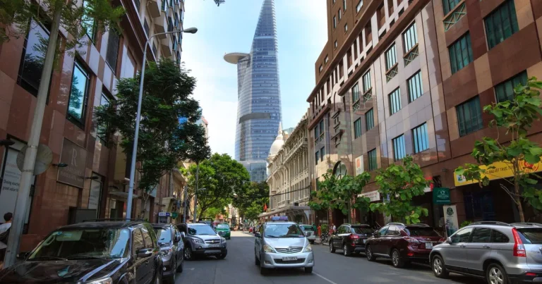 Split-view Ho Chi Minh City rental lifestyle scene, one side showing District 1 CBD towers and busy central streets, the other side showing leafy District 3 streets with cafes and older villas, daylight, realistic editorial style, no text, no logos